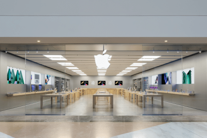 Apple Store in France with a glass storefront and illuminated Apple logo.