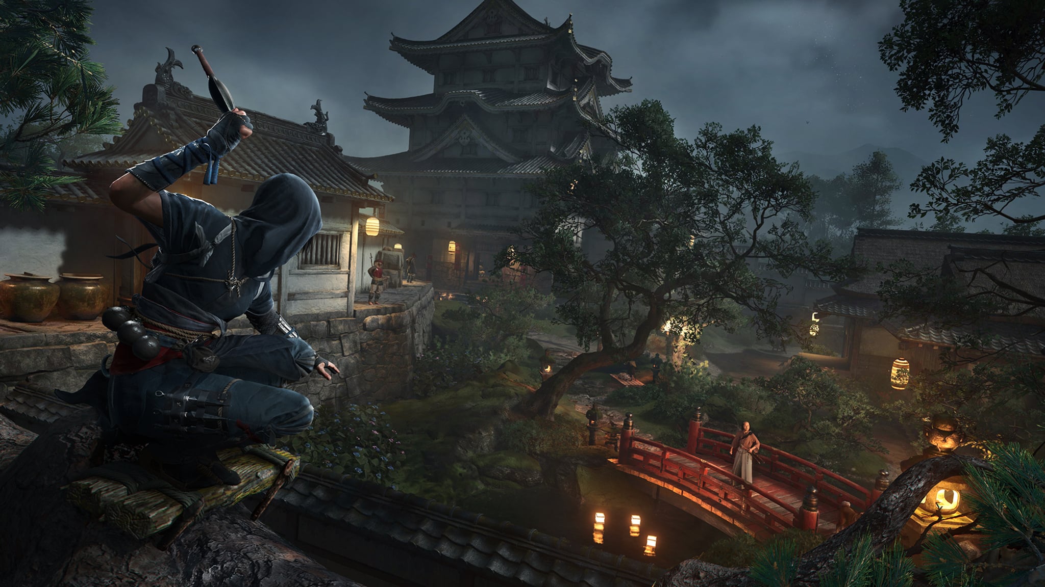 A hooded Shinobi assassin crouches on a rooftop at night, overlooking a Japanese castle.