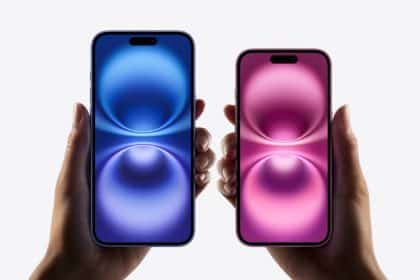 Two hands holding iPhone models in blue and pink with glowing wallpaper.