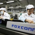 Foxconn factory workers assembling electronic components.