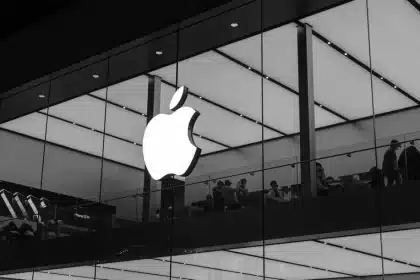 Black and white image of an Apple Store with a glowing Apple logo.